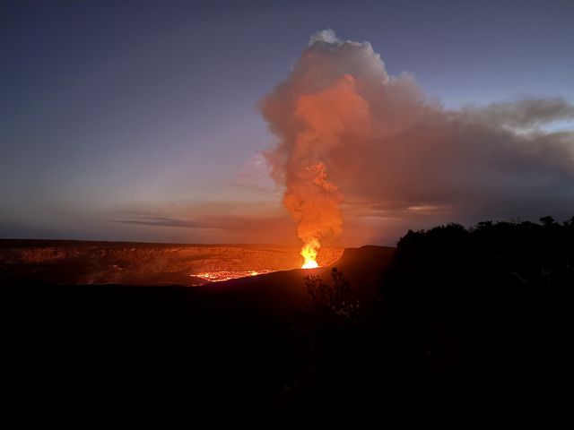 Lava fountain and glowing plume at Kīlauea at dusk