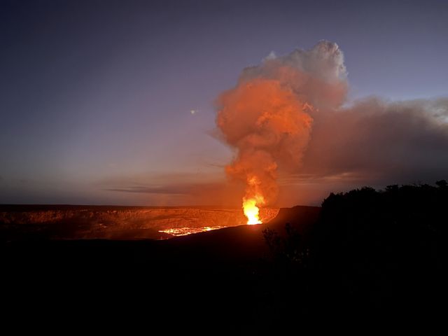 Lava fountain and glowing plume at Kīlauea at dusk