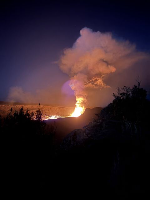Lava fountain and glowing plume at Kīlauea at dusk